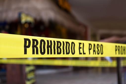 Yellow no cross tape with sign - Prohibido El Pasa